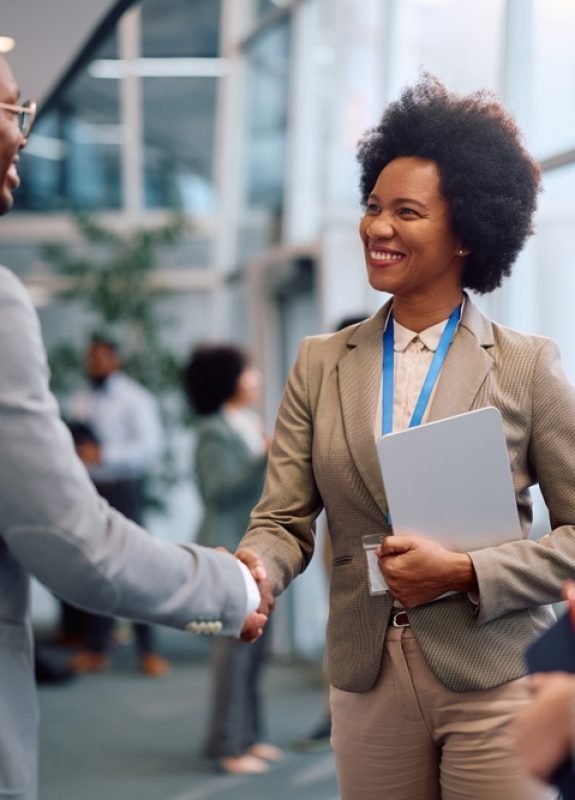 Happy,Entrepreneurs,Shaking,Hands,While,Greeting,During,Business,Seminar,In